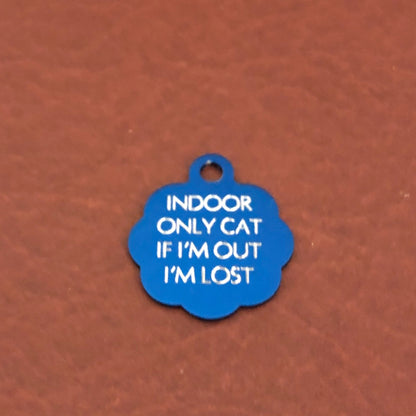 Small blue rosette tag that says: Indoor only cat If I&#39;m out I&#39;m lost. All engraved in capital letters.