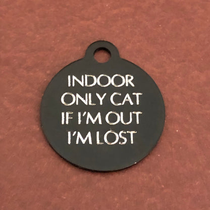 Small black circle tag that says: Indoor only cat If I'm out I'm lost. All engraved in capital letters.